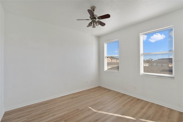 unfurnished room featuring a textured ceiling, light hardwood / wood-style flooring, and ceiling fan