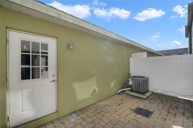 entrance to property featuring cooling unit and a patio area