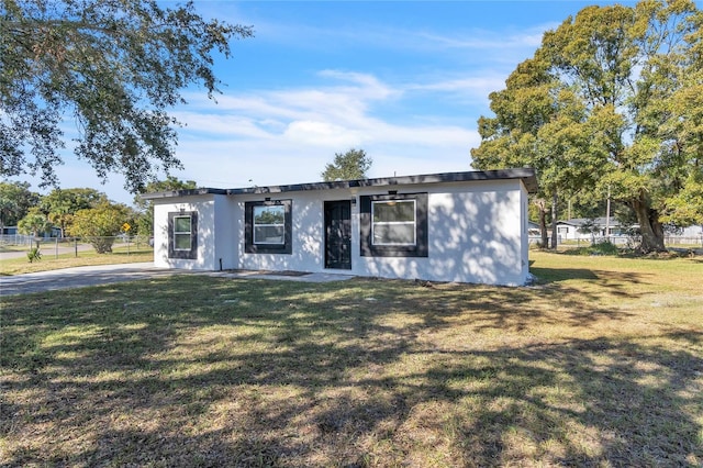 ranch-style home featuring a front lawn