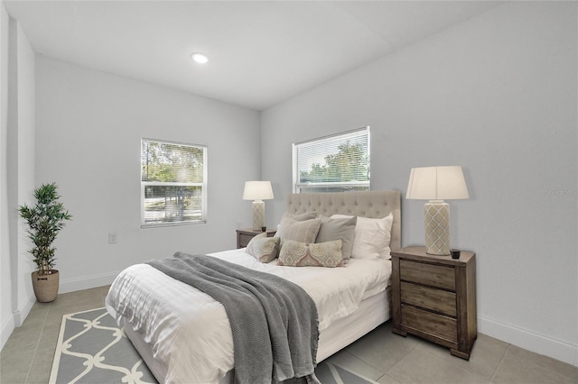 tiled bedroom with multiple windows