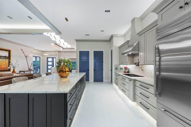 kitchen featuring gray cabinetry, tasteful backsplash, black electric cooktop, and high end refrigerator