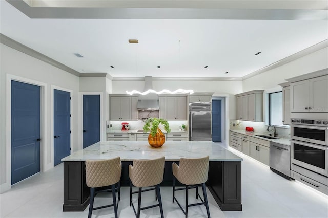 kitchen featuring pendant lighting, gray cabinets, a spacious island, and appliances with stainless steel finishes