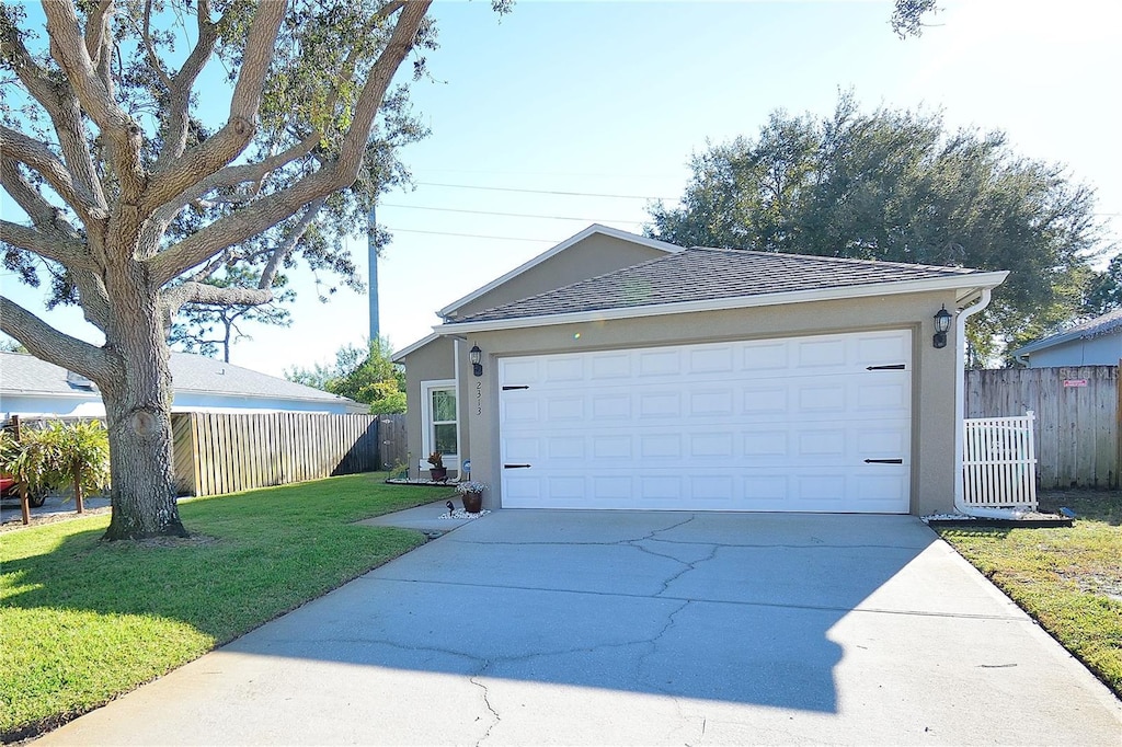 view of front of property featuring a garage and a front lawn