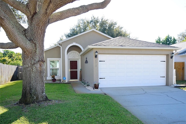 single story home with a garage and a front lawn