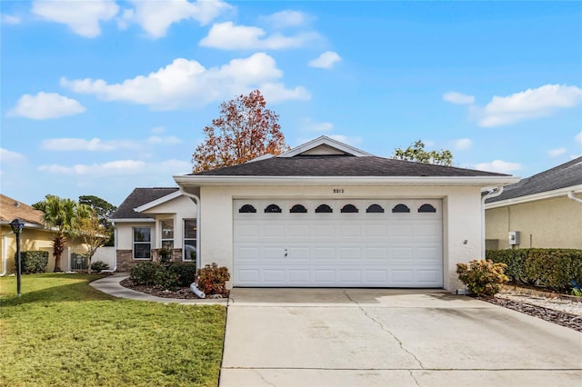 single story home featuring a garage and a front yard