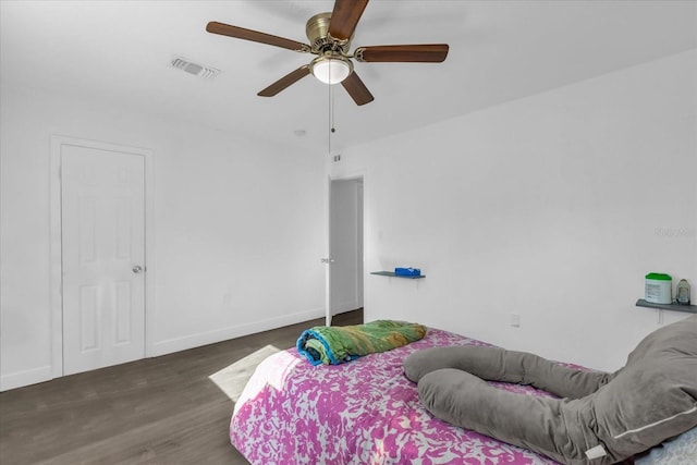 bedroom with dark wood-type flooring and ceiling fan