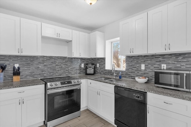 kitchen featuring white cabinetry, sink, backsplash, and stainless steel appliances