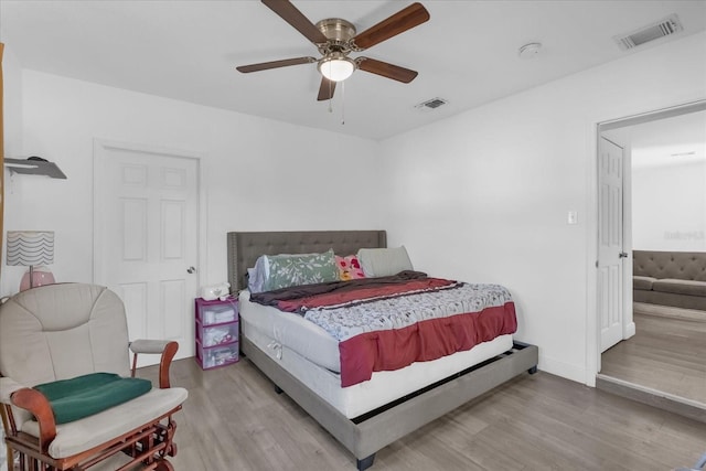 bedroom with ceiling fan and light hardwood / wood-style floors