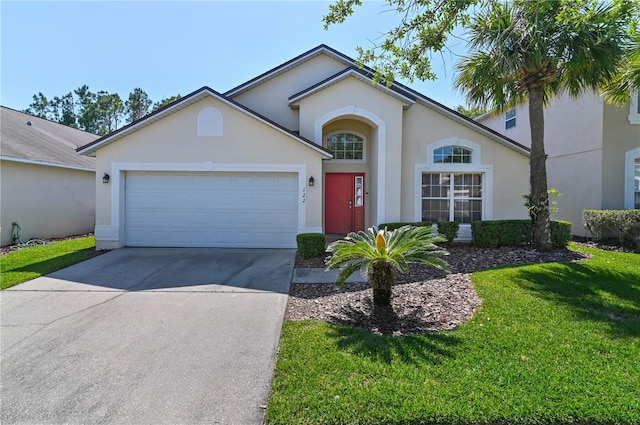 ranch-style house featuring a front yard and a garage