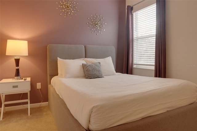 carpeted bedroom with a chandelier and multiple windows