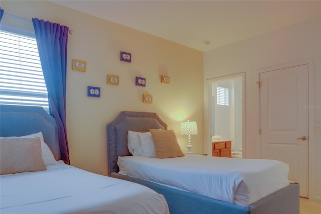 carpeted bedroom with ensuite bathroom