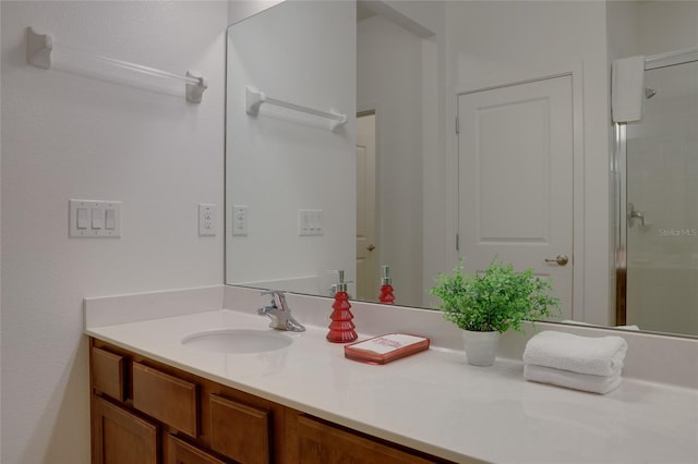 bathroom featuring vanity and a shower with shower door