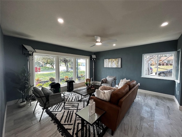 living room with baseboards, a ceiling fan, and recessed lighting