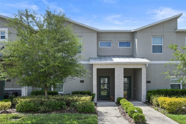 820 Pebble Beach Dr, Davenport, FL 33896 - view of front facade with a standing seam roof and stucco siding