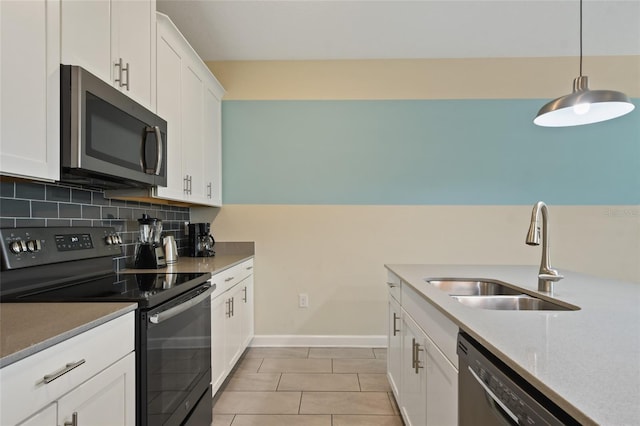 kitchen featuring appliances with stainless steel finishes, tasteful backsplash, sink, decorative light fixtures, and white cabinets