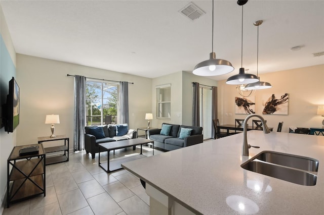 820 Pebble Beach Dr, Davenport, FL 33896 - kitchen with pendant lighting, light tile patterned floors, open floor plan, and light stone countertops
