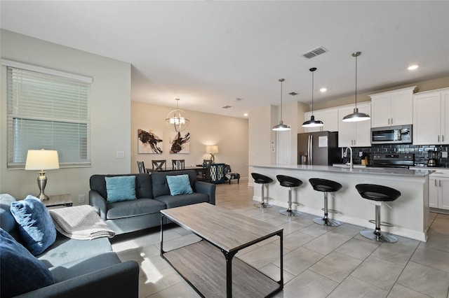 820 Pebble Beach Dr, Davenport, FL 33896 - living area featuring a chandelier, light tile patterned floors, and recessed lighting