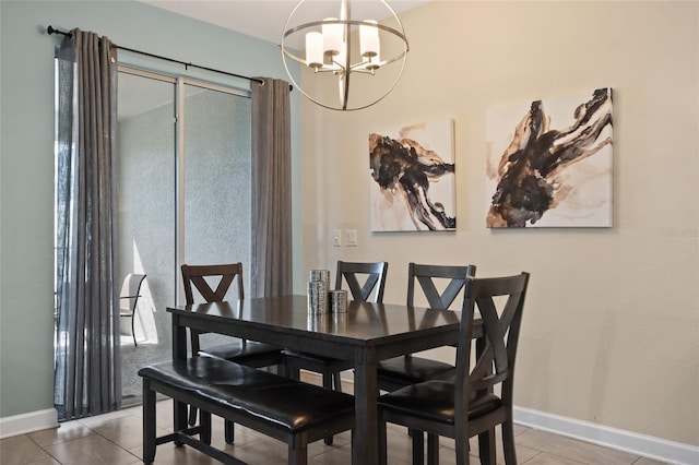 dining area featuring tile patterned floors and a notable chandelier