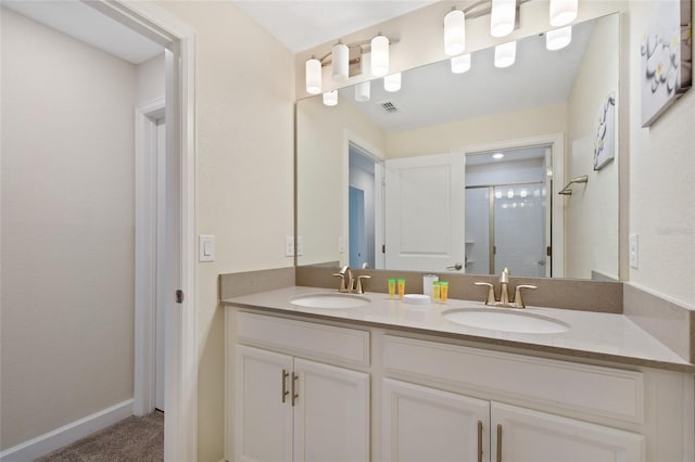 bathroom with vanity and a shower with shower door