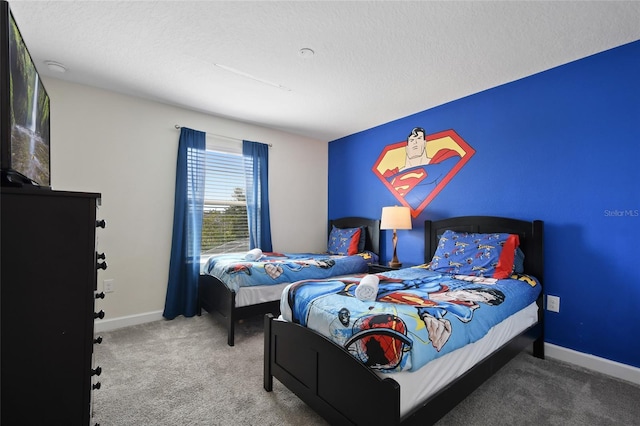 bedroom featuring carpet floors and a textured ceiling