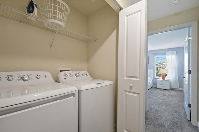 laundry room featuring washer and dryer and light carpet