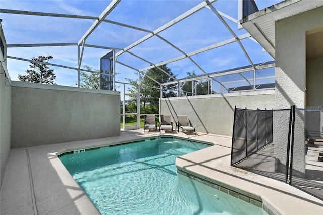 view of swimming pool with a lanai and a patio area