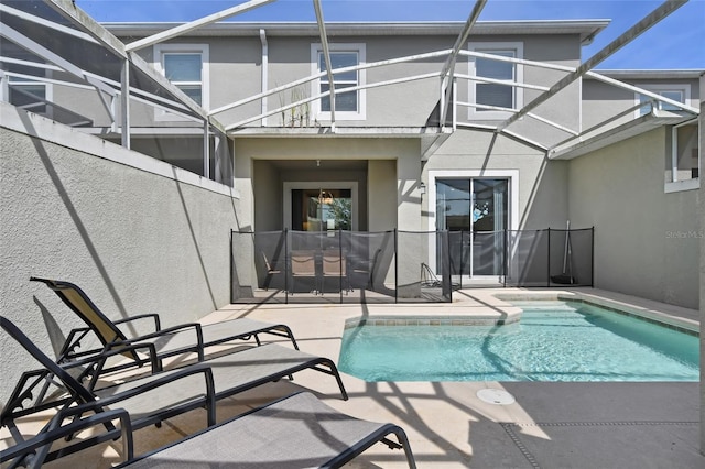 820 Pebble Beach Dr, Davenport, FL 33896 - back of property with a patio area, stucco siding, and a lanai