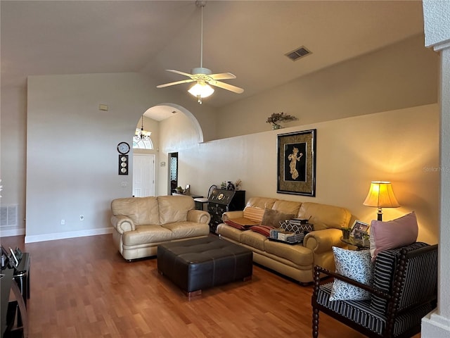 living room with ceiling fan, hardwood / wood-style floors, and lofted ceiling