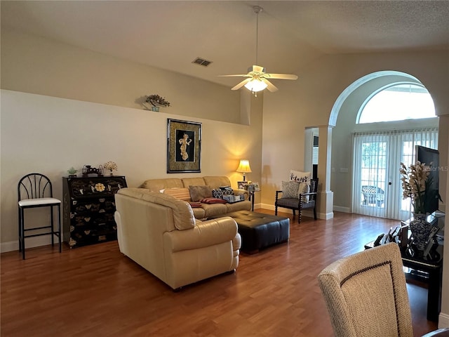 living room with dark hardwood / wood-style floors, vaulted ceiling, and ceiling fan