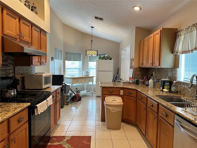 kitchen with sink, a textured ceiling, lofted ceiling, white appliances, and light tile patterned floors