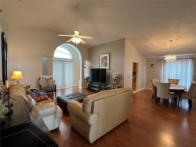 living room featuring a textured ceiling, dark hardwood / wood-style flooring, ceiling fan with notable chandelier, and vaulted ceiling