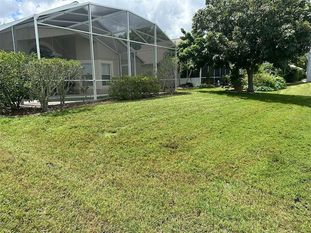 view of yard with glass enclosure