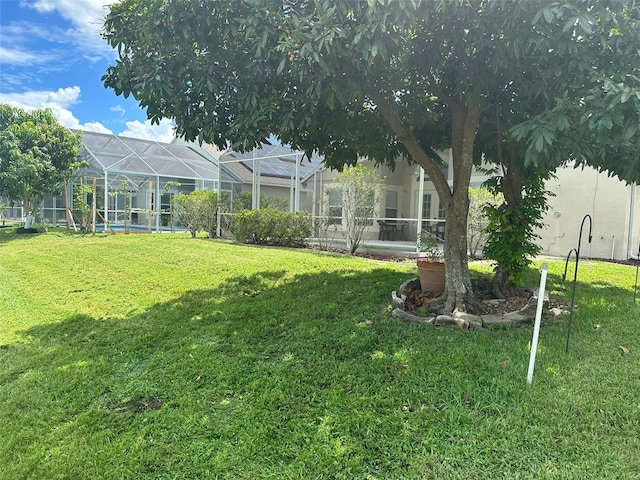 view of yard featuring glass enclosure