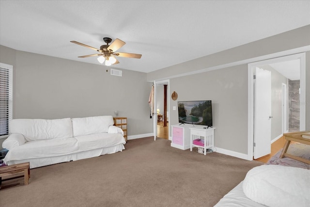 carpeted living room with ceiling fan