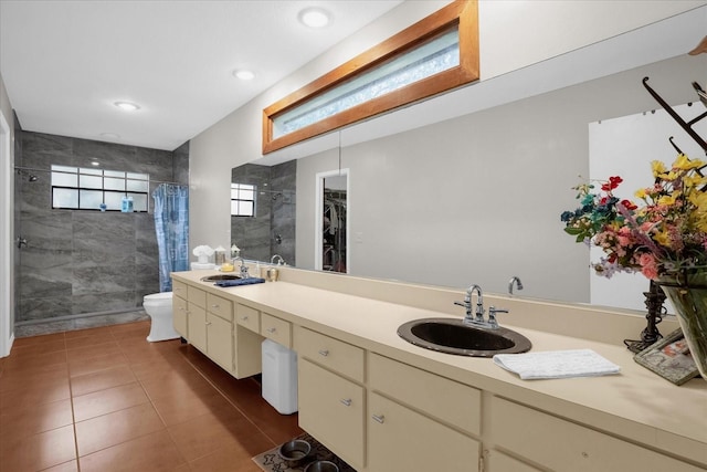 bathroom with tile patterned flooring, a shower with curtain, vanity, and toilet