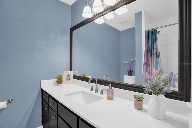 bathroom featuring walk in shower, vanity, and toilet