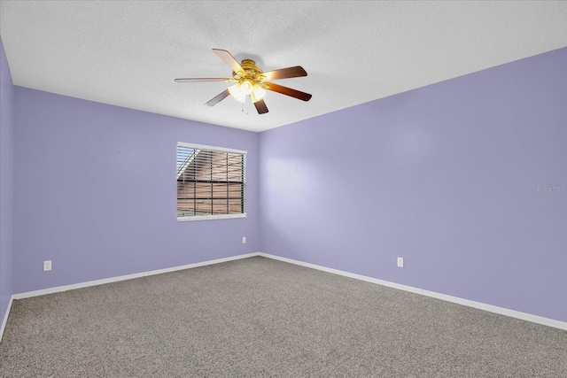 carpeted empty room featuring ceiling fan and a textured ceiling