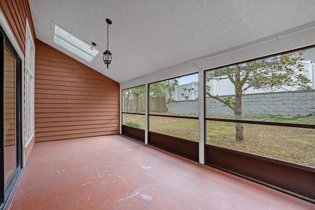 unfurnished sunroom with vaulted ceiling with skylight