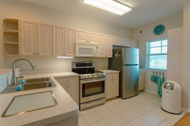 kitchen featuring sink, light tile patterned floors, and stainless steel appliances