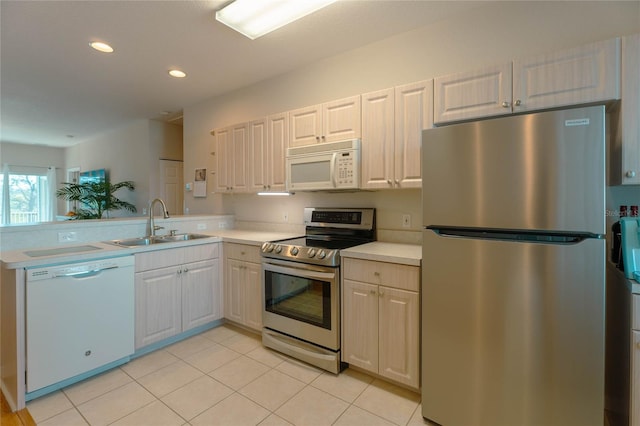 kitchen with sink, white cabinets, and appliances with stainless steel finishes