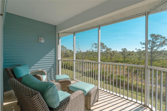 sunroom featuring beam ceiling