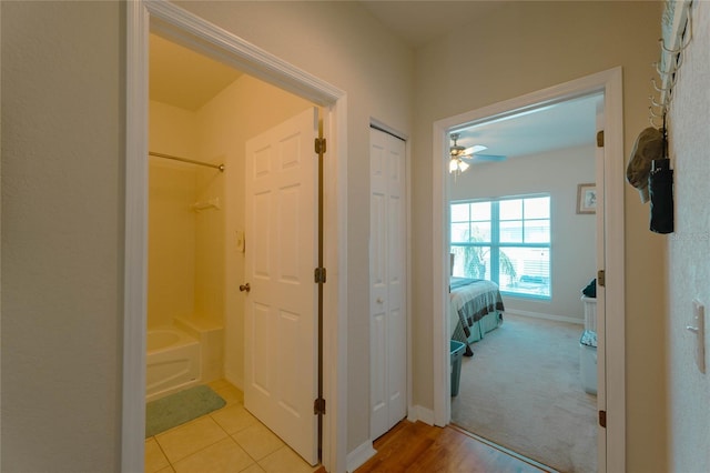 hall with light colored carpet