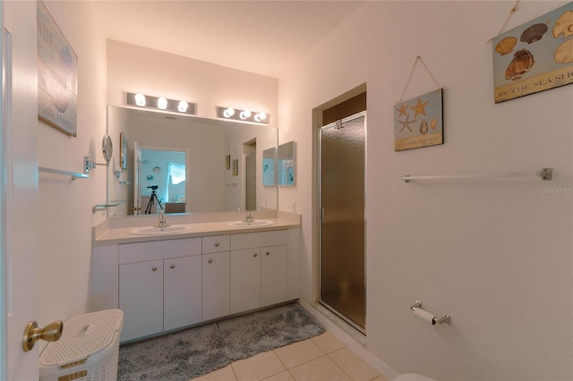 bathroom featuring tile patterned flooring, a textured ceiling, vanity, and a shower with shower door