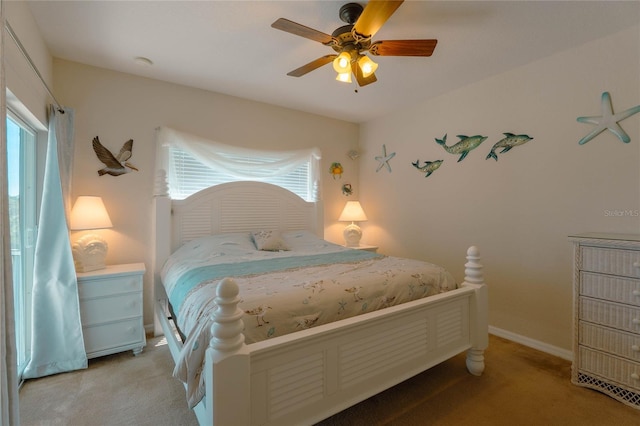 carpeted bedroom with multiple windows and ceiling fan