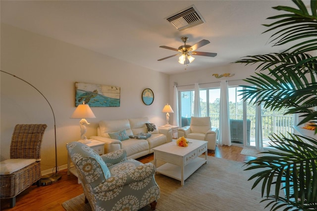 living room featuring light hardwood / wood-style flooring and ceiling fan