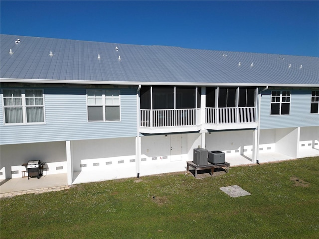 rear view of property with a patio area, a yard, and central AC unit