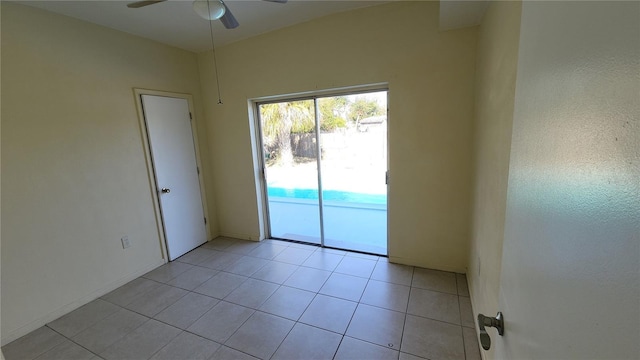 spare room with ceiling fan and light tile patterned flooring