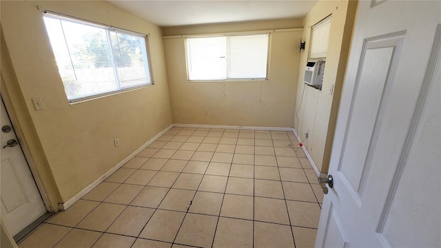 spare room with light tile patterned floors and cooling unit