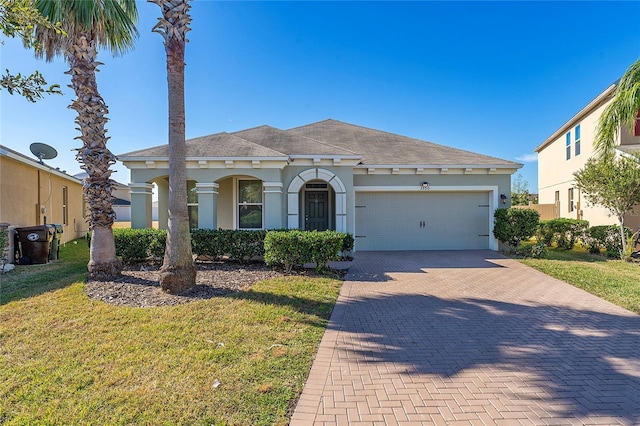 view of front of property featuring a garage and a front yard