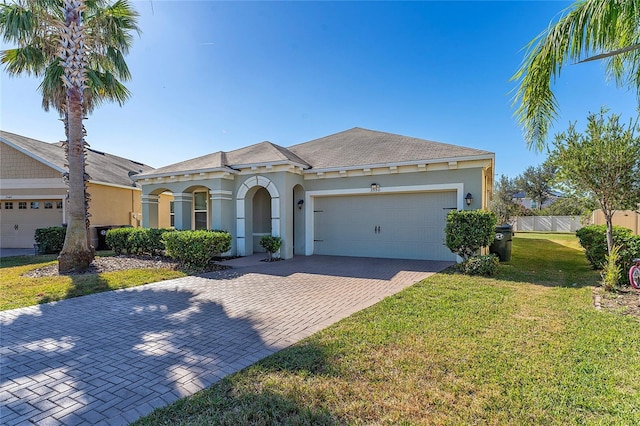 view of front of house with a garage and a front yard